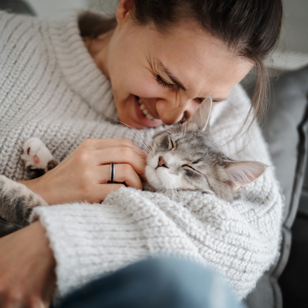 Woman snuggling her hcat after an urgent pet care visit in Middle Island NY